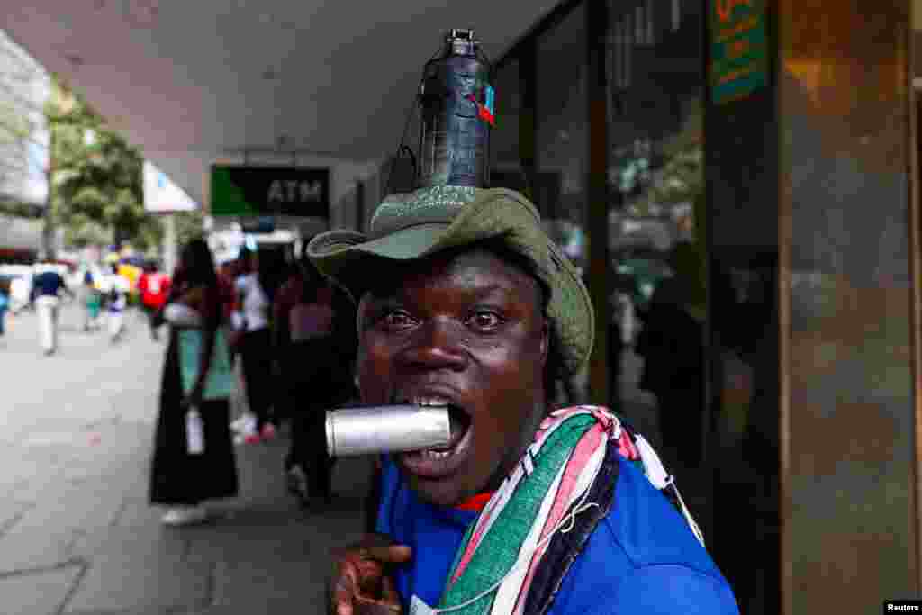 A man has a grenade attached to his head as activists and civil society members participate in a nationwide march titled &quot;End Femicide Kenya&quot; to raise awareness about gender-based violence (GBV) in downtown Nairobi.