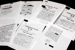FILE - Classified Chinese government documents leaked to news organizations are displayed in New York, Nov. 22, 2019. Beijing has detained more than a million Uighurs and other Muslim minorities for what it calls voluntary job training.