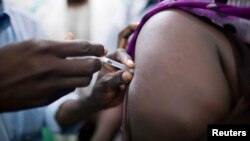 FILE - Staff members of the Teaching Hospital receive the first vaccination treatment for yellow fever in El Geneina, West Darfur in this Nov. 14, 2012 handout. 