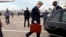 U.S. Secretary of State John Kerry walks into his vehicle on arrival in Paris, March 29, 2014. 