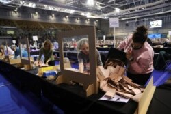 Election staff members count votes for the Scottish parliamentary election at a counting center in Glasgow, Scotland, May 8, 2021.
