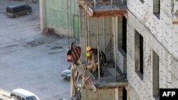 FILE- North Korean workers at a construction site in the capital Ulaanbaatar on October 6, 2017. 