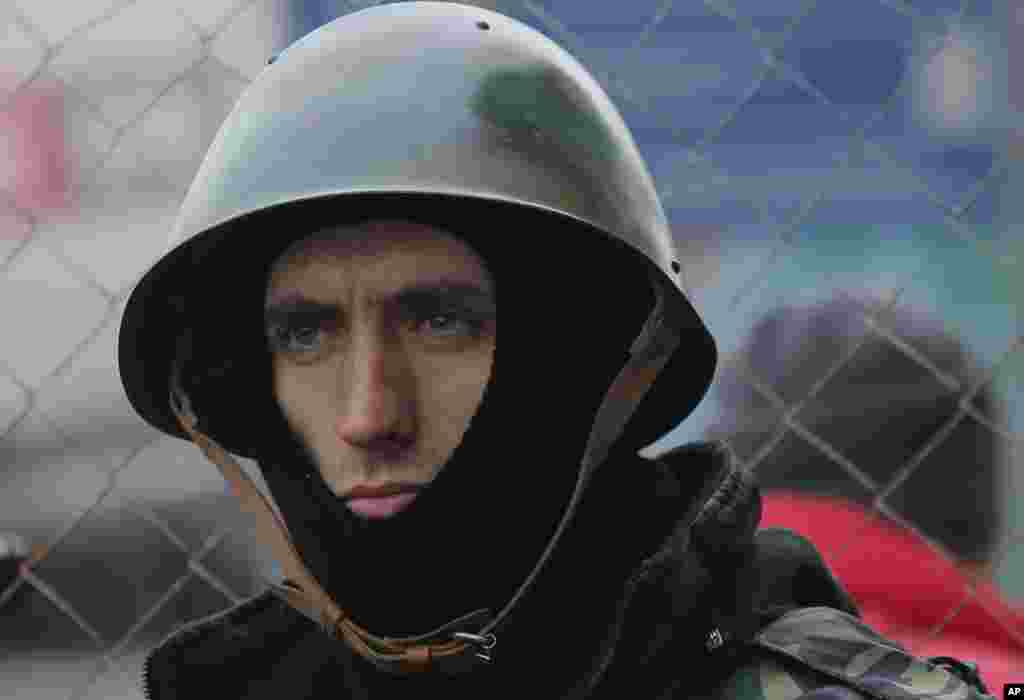 A Pro-European Union activist guards an entrance to the tent camp in Independence Square in Kyiv, Ukraine, Dec. 19, 2013. 