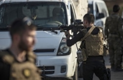 Members of the special forces of the Kurdish-led Syrian Democratic Forces (SDF) prepare to join the front against Turkish forces, near the northern Syrian town of Hasakeh, Oct. 10, 2019.