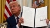 Trump signs executive orders on AI, cryptocurrency and issues more pardons 