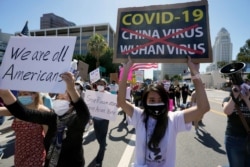 FILE - Protesters march at a rally against Asian hate crimes past the Los Angeles Federal Building in downtown Los Angeles, March 27, 2021.