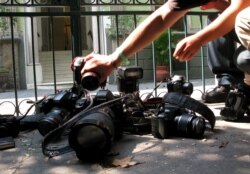 FILE - In this April 29, 2012, photo, photojournalists place their cameras on the ground during a demonstration in Mexico City condemning the alleged murder of fellow journalist Regina Martinez.
