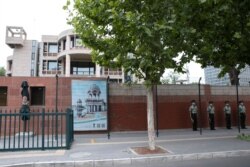 Chinese paramilitary policemen stand guard outside the Indian embassy in Beijing, June 17, 2020.