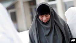 FILE - The E.U.’s highest court has ruled that employers can ban some religious symbols, including headscarves, in the workplace. In this photo, women gathered in 2009 to protest a ban of religious and political symbols at secondary schools in Antwerp, Belgium.