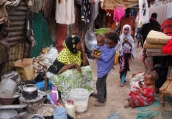 FILE - Residents live in crowded conditions in the Sayidka camp for internally displaced people in Mogadishu, Somalia, March 26, 2020.