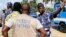 A policeman gestures at a journalist during a sit-in near the presidency, to protest against a new media law in Lome, Togo, March 14, 2013. 
