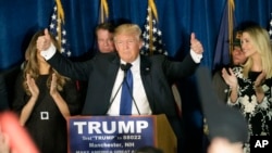 Republican presidential candidate, businessman Donald Trump gives thumbs up to supporters during a primary night rally, Tuesday, Feb. 9, 2016.