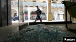 A passerby inspects the site of a blast that hit central Cairo Tuesday. A man was killed in a bomb blast in Alexandria, Egypt, hours after two devices were discovered at Cairo airport, Feb. 3, 2015.