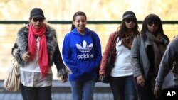 Daughter Zenani Dlamini-Mandela, left, with granddaughters Swati Dlamini, second right, and Zaziwe Dlamini-Manaway, right, and an unidentified family member arrive at the Mediclinic Heart Hospital , June 19, 2013.