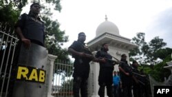 FILE - Members of the controversial Rapid Action Battalion (RAB) stand guard in front of the high court in Dhaka, Bangladesh, Aug. 1, 2013.