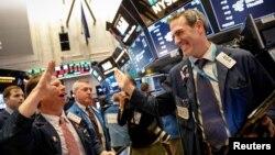 Traders celebrate after the closing bell on the floor of the New York Stock Exchange, (NYSE) in New York, Feb. 6, 2018.