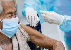 An elderly woman gets vaccinated at the Central Vaccination Center with the AstraZeneca vaccine in Bangkok on July 26, 2021. Soe Zeya Tun/Reuters
