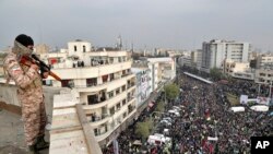 FILE - An Iranian soldier stands guard overlooking a protest in Tehran, Iran, Nov. 25, 2019.