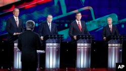 Republican presidential candidates, from left, George Pataki, Mike Huckabee, Rick Santorum, and Lindsey Graham respond to moderator Wolf Blitzer during the GOP presidential debate, Dec. 15, 2015, in Las Vegas.
