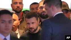 Ukrainian President Volodymyr Zelenskyy, center, arrives at the Shangri-La Hotel, the venue of the 21st Shangri-La Dialogue summit, in Singapore on June 1, 2024.