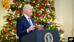 President Joe Biden speaks about the COVID-19 response and vaccinations, in the State Dining Room of the White House in Washington, Dec. 21, 2021.