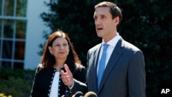 Acting Secretary of Homeland Security Elaine Duke, left, listens as Homeland Security Adviser Tom Bossert speaks about hurricane recovery efforts in Puerto Rico, outside the White House, Sept. 28, 2017, in Washington.