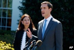 Acting Secretary of Homeland Security Elaine Duke, left, listens as Homeland Security Adviser Tom Bossert speaks about hurricane recovery efforts in Puerto Rico, outside the White House, Sept. 28, 2017, in Washington.
