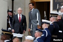 U.S. Secretary of Defense Jim Mattis stands with Qatari Emir Sheikh Tamim bin Hamad al-Thani during an Enhanced Honor Cordon at the Pentagon in Arlington, Virginia, near Washington, April 9, 2018.