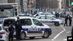 French police forces block a street during an operation in the Neudorf district of Strasbourg, eastern France, Thursday, Dec. 13, 2018.