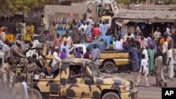 FILE - Nigerian soldiers patrol a market after recent violence in areas surrounding Maiduguri, Jan. 27, 2015.