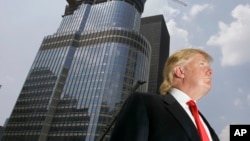 FILE - Donald Trump is profiled against his 92-story Trump International Hotel & Tower during a news conference on construction progress in Chicago.