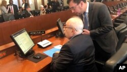 Gustavo Tarre, seated, Venezuelan representative to the Organization of American States designated by opposition leader Juan Guaido, gets ready before delivering a speech during an ordinary session at organization headquarters in Washington, April 23, 201