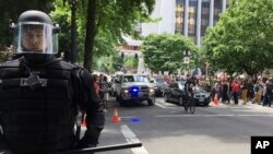 FILE - Thousands of protesters gather in Portland, Ore., for competing rallies following last month's fatal stabbing of two men on a light-rail train by a man police say was shouting anti-Muslim slurs. Marches against Islamic law are scheduled in more than two dozen cities across the United States, June 10, 2017. Counter-demonstrations were also planned.