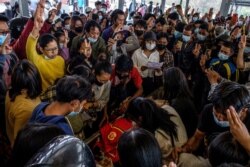 Mourners make the three-finger salute as they attend the funeral of a protester, who died amid a crackdown by security forces on demonstrations against the military coup, in Taunggyi in Myanmar's Shan state on March 29, 2021.