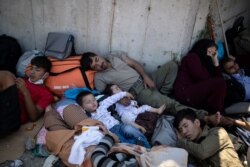 Refugees and migrants sleep next to a road following a fire at the Moria camp on the island of Lesbos, Greece, Sept. 9, 2020.