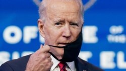 U.S. President-elect Joe Biden adjusts his face mask as he speaks about his plan to administer coronavirus disease vaccines to the U.S. population, during a news conference at Biden's transition headquarters in Wilmington, Del., Jan. 15, 2021.