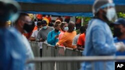 People wait in line to be tested for COVID-19 during a free, government testing campaign in Panama City, Jan. 15, 2021. Panama is waiting for its first shipment of doses of the vaccine against the new coronavirus, expected next week. 