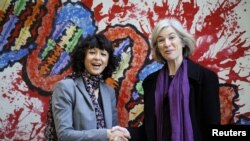 La microbiologiste française Emmanuelle Charpentier (à gauche) et la professeure Jennifer Doudna des États-Unis lors d'une visite à une exposition de peintures d'enfants sur le génome, en Espagne, le 21 octobre 2015.