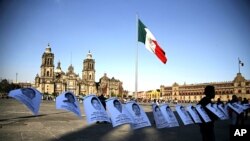 Foto-foto 43 mahasiswa yang hilang di negara bagian Guerrero, dipasang di Zocalo, Mexico City (1/12). (AP/Eduardo Verdugo)