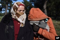 Syrian refugees shelter from the cold weather on the outskirts of the northern Greek city of Thessaloniki, Nov. 30, 2016.