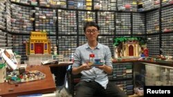Hoang Dang, an industrial designer who loves Lego since he was a child poses in front of his pieces at his home in Hanoi, Vietnam March 13, 2021. (REUTERS/Minh Nguyen)