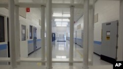 FILE - An empty corridor is seen a correctional facility in Baldwin, Michigan, Nov. 3, 2005. Plans for an immigrant detention center in Ionia, Michigan, have been suspended. 