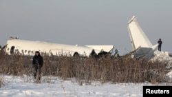 Emergency and security personnel are seen at the site of a plane crash near Almaty, Kazakhstan, Dec. 27, 2019. 