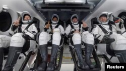 NASA astronauts Shannon Walker, left, Victor Glover, Mike Hopkins, and Japan Aerospace Exploration Agency (JAXA) astronaut Soichi Noguchi react inside the SpaceX Crew Dragon Resilience spacecraft onboard the SpaceX GO Navigator recovery ship May 2, 2021. (NASA/Bill Ingalls)