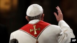 Pope Francis waves as he presides over the Via Crucis (Way of the Cross) torchlight procession on Good Friday in front of Rome's Colosseum, April 14, 2017. 