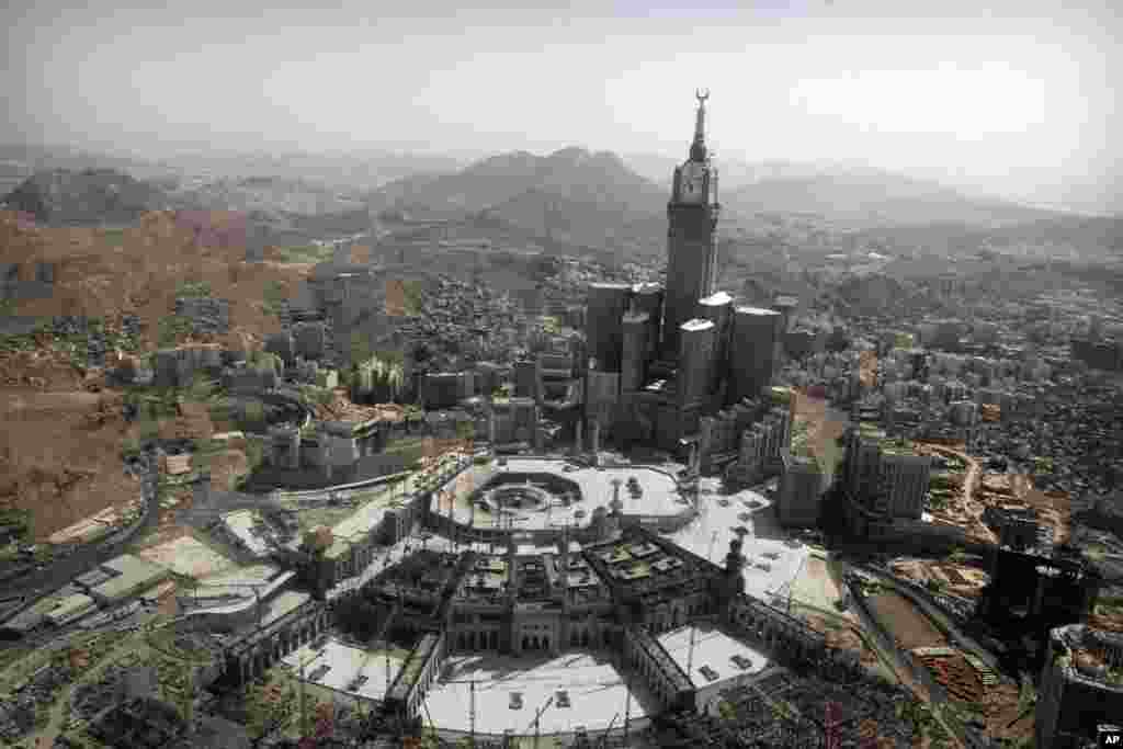 The tallest clock tower in the world with the world's largest clock face at the Abraj Al-Bait Towers overlooks the Grand Mosque and its expansion in Mecca, Saudi Arabia, Oct. 16, 2013.