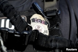 FILE - A U.S. Immigration and Customs Enforcement badge.