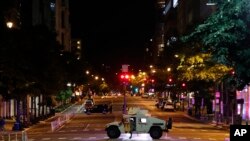 A military Humvee blocks an intersection along K Street in downtown Washington as demonstrators protest the death of George Floyd, June 1, 2020, in Washington. 