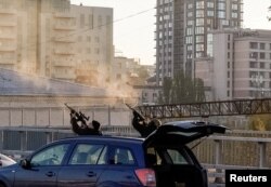 FILE PHOTO: Police officers shoot at a drone during a Russian drone strike in Kyiv