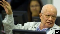 In this photo released by the Extraordinary Chambers in the Courts of Cambodia, Khieu Samphan, former Khmer Rouge head of state, gestures as he sits in the court room U.N.-backed war crimes tribunal in Phnom Penh, file photo. 